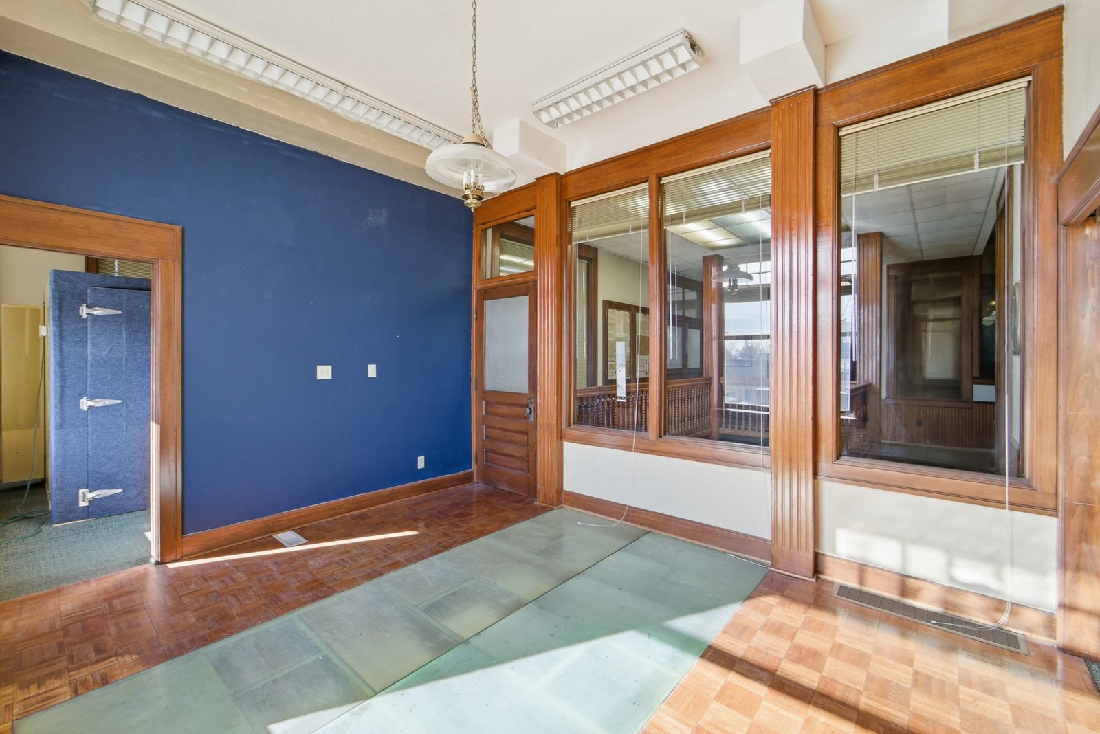 Room with blue accent wall and historic windows