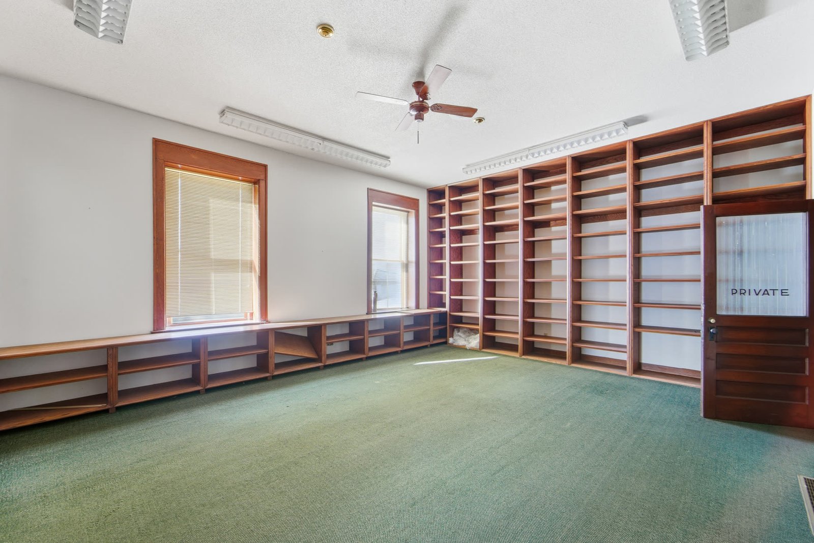Interior with ceiling fan and large windows