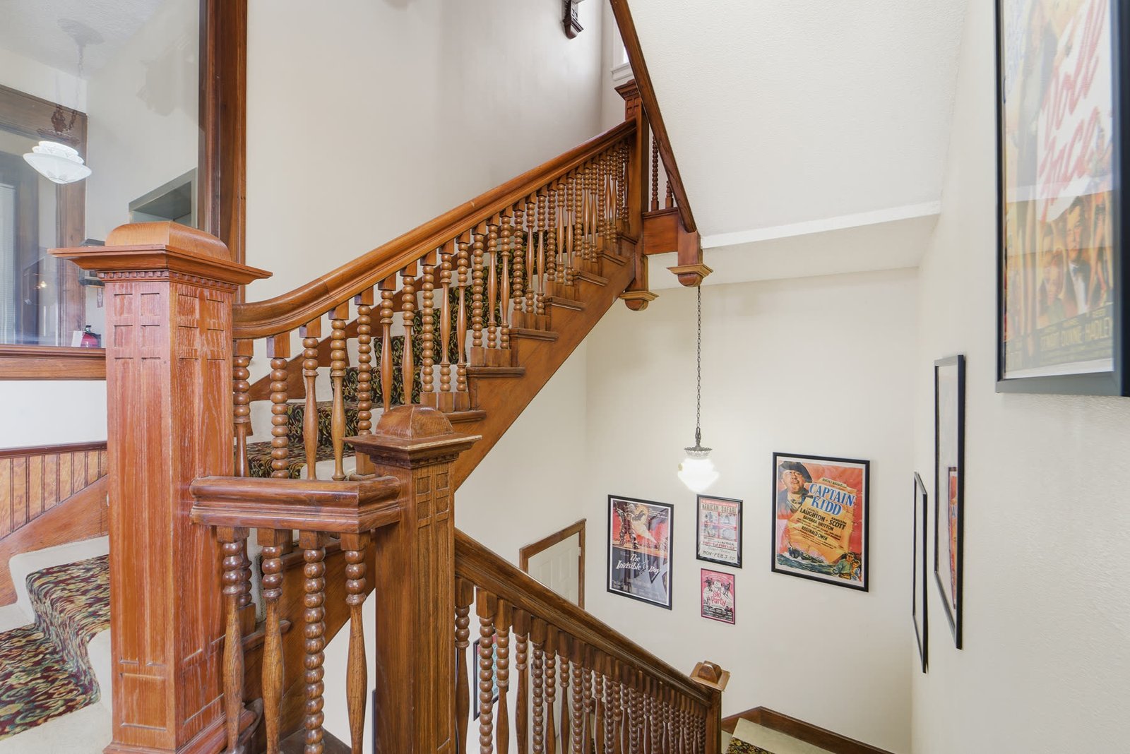 Original wood staircase and vintage posters