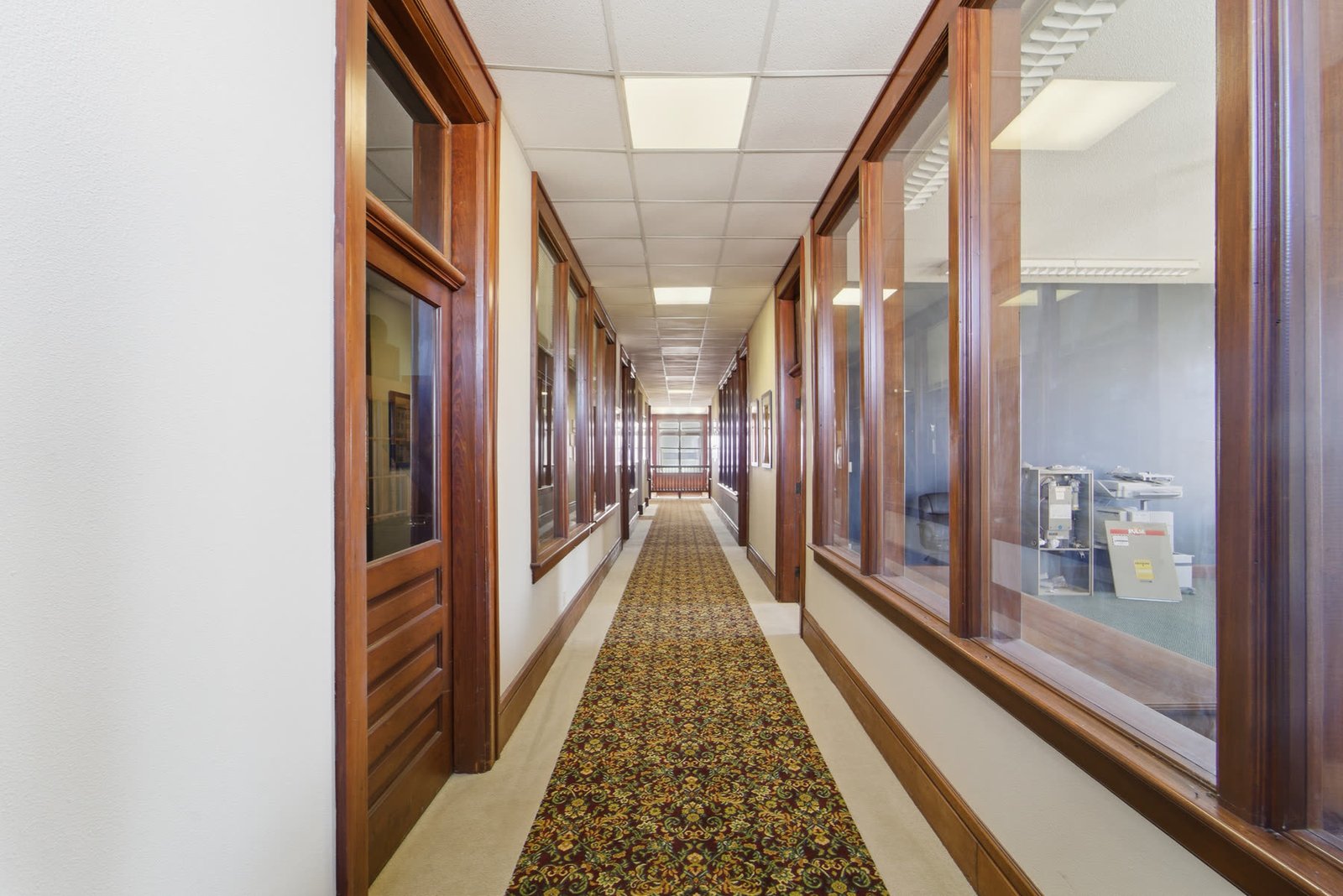 Grand historic staircase with original woodwork inside Clock Tower Lofts